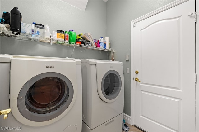 washroom with washing machine and dryer and laundry area