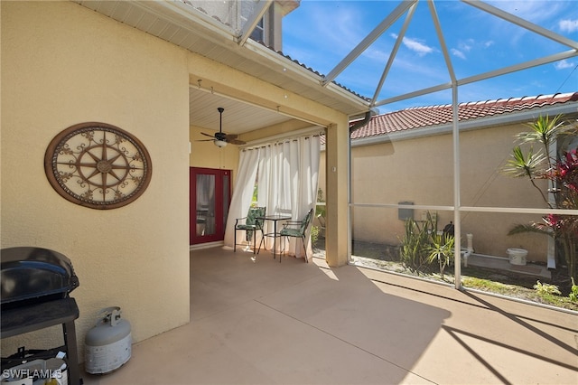 view of patio / terrace featuring glass enclosure and ceiling fan