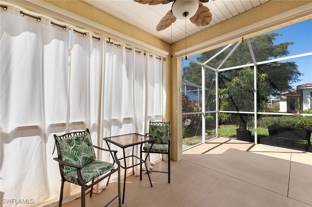 sunroom / solarium featuring ceiling fan