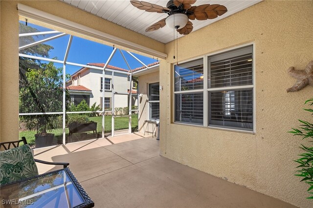 unfurnished sunroom featuring a ceiling fan