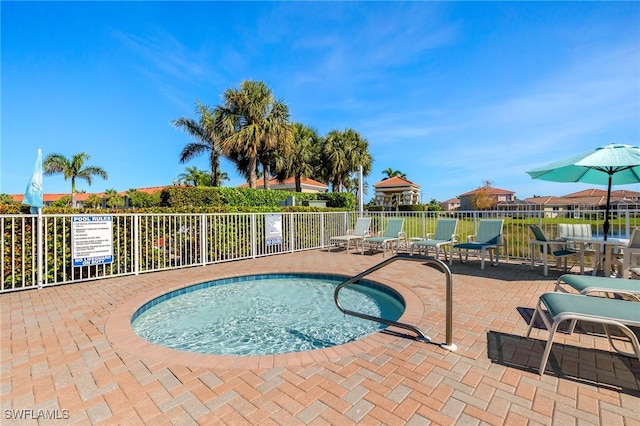 view of swimming pool with fence and a patio