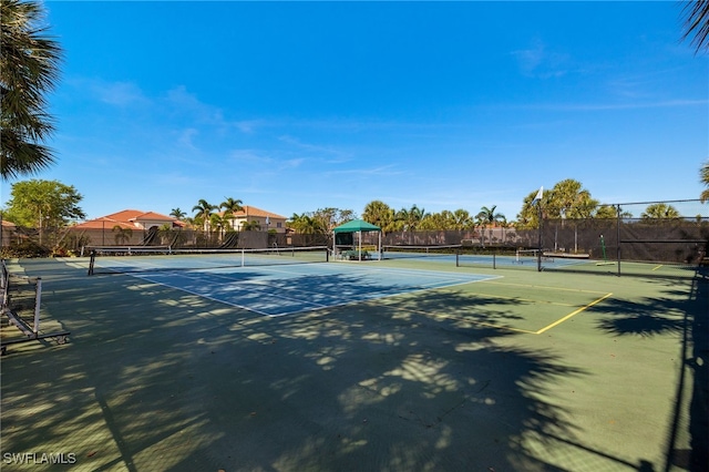 view of tennis court featuring fence