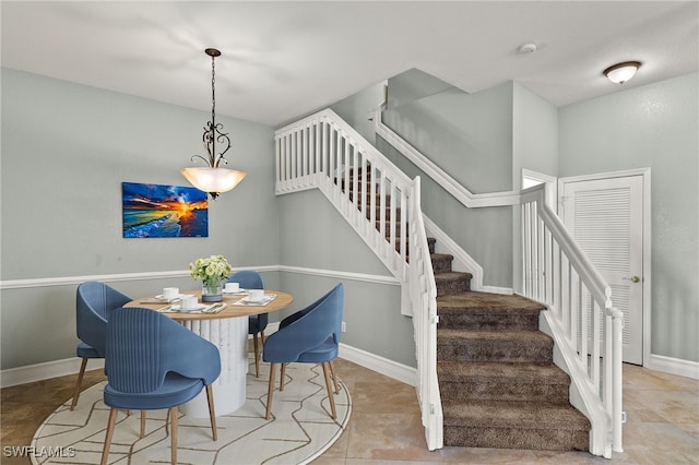 dining area with baseboards and stairway