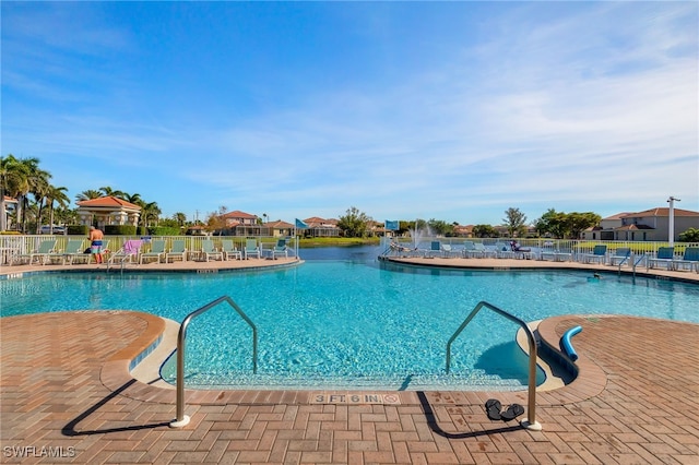 pool featuring fence and a patio