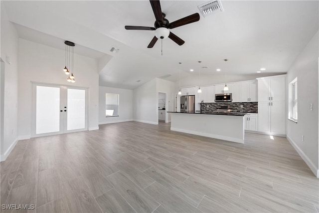 unfurnished living room featuring visible vents, light wood-style floors, french doors, and a ceiling fan