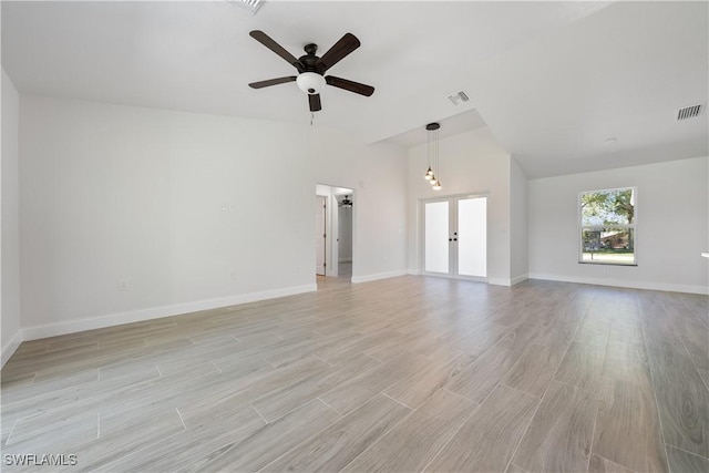 unfurnished living room featuring light wood-type flooring, baseboards, visible vents, and a ceiling fan