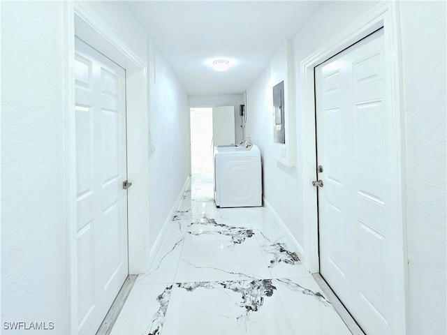 hall featuring electric panel, baseboards, marble finish floor, and washer / dryer