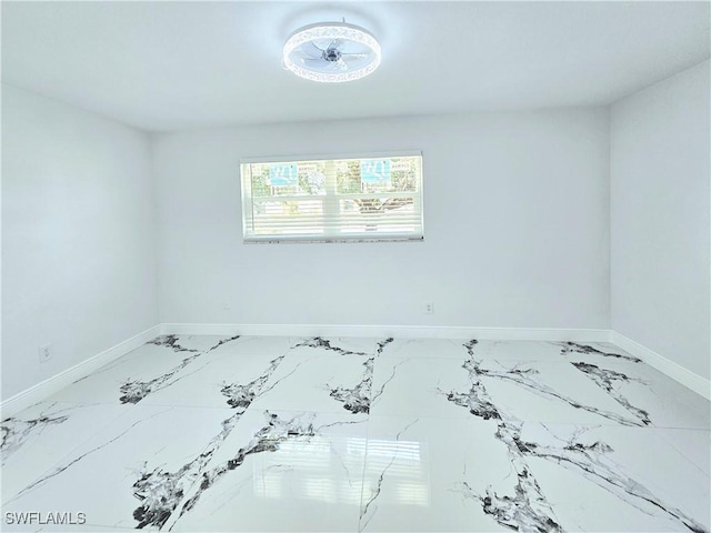 1312 Archdale St, Lehigh Acres, FL 33936 - spare room with baseboards and marble look tile flooring