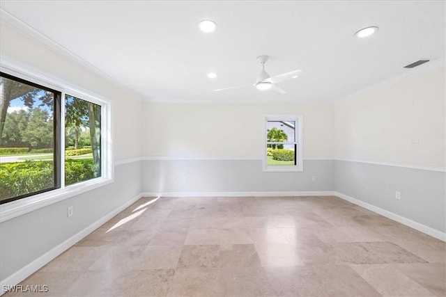 spare room with baseboards, visible vents, a ceiling fan, and plenty of natural light
