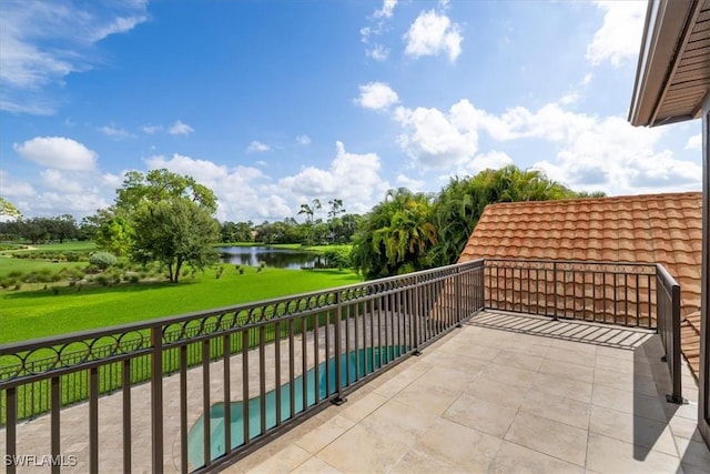 balcony with a water view and a patio area