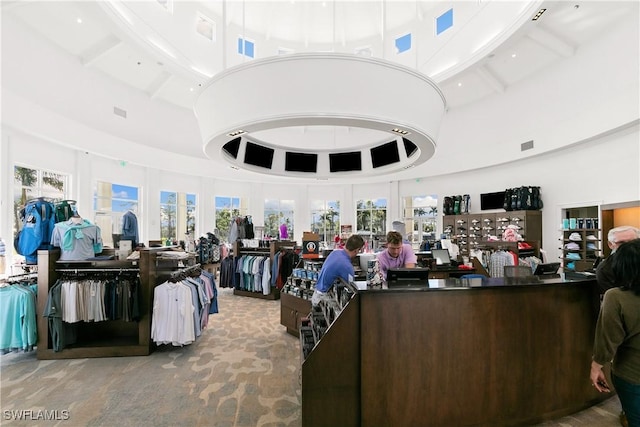 interior space with a towering ceiling, beam ceiling, and visible vents