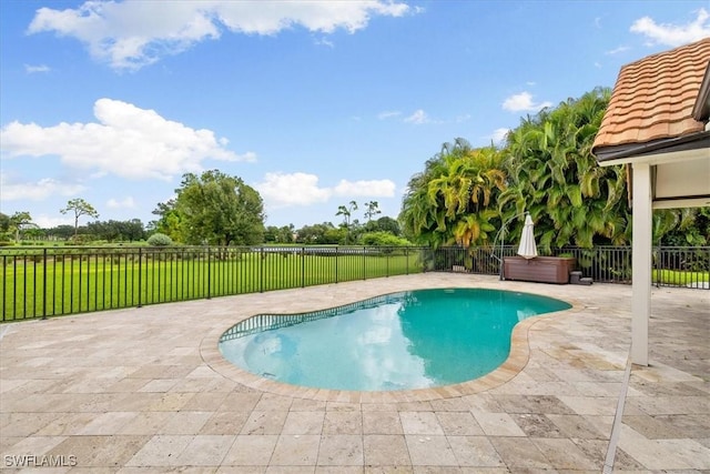 view of pool with a patio, a fenced in pool, a fenced backyard, a hot tub, and a lawn
