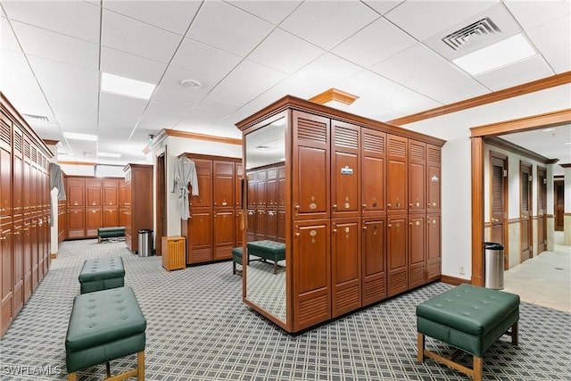 interior space with crown molding, light colored carpet, and visible vents