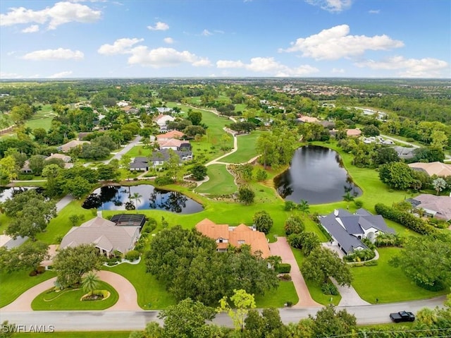 drone / aerial view with a residential view, golf course view, and a water view