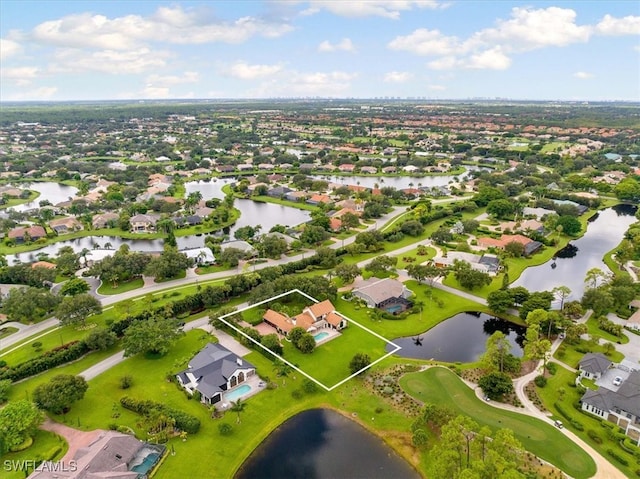 drone / aerial view featuring a residential view and a water view