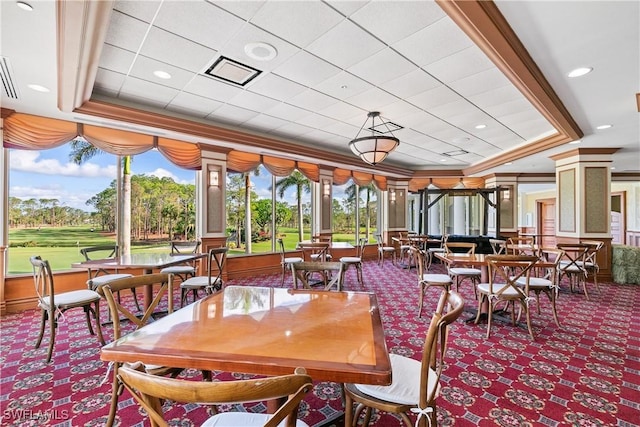 carpeted dining room featuring ornamental molding, a tray ceiling, and visible vents