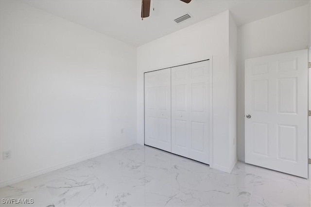 1508 Hibiscus Ave, Lehigh Acres, FL 33972 - unfurnished bedroom featuring marble finish floor, a closet, baseboards, and visible vents