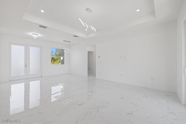 1508 Hibiscus Ave, Lehigh Acres, FL 33972 - unfurnished room featuring a tray ceiling, french doors, marble finish floor, visible vents, and recessed lighting