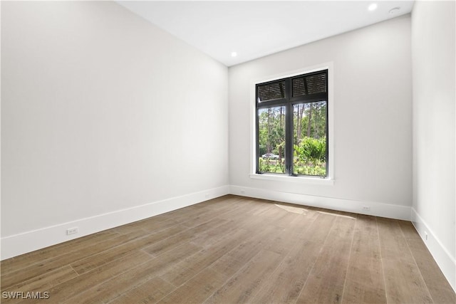 4987 Mahogany Ridge Dr, Naples, FL 34119 - empty room with wood finished floors, recessed lighting, and baseboards