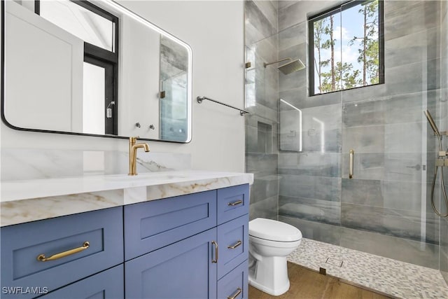 4987 Mahogany Ridge Dr, Naples, FL 34119 - full bathroom featuring toilet, vanity, a shower stall, and wood finished floors