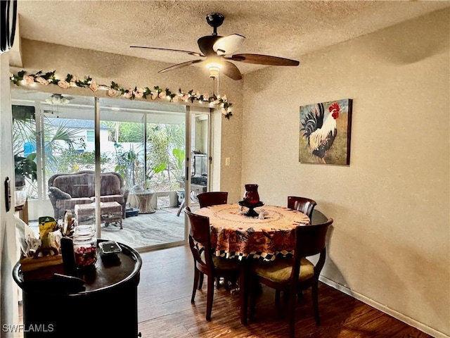 1148 Barbour Ave, Port Charlotte, FL 33948 - dining room featuring a ceiling fan, wood finished floors, a textured ceiling, a textured wall, and baseboards