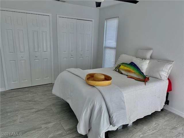 17304 Timber Oak Ln, Fort Myers, FL 33908 - bedroom with multiple closets, marble finish floor, baseboards, visible vents, and ceiling fan