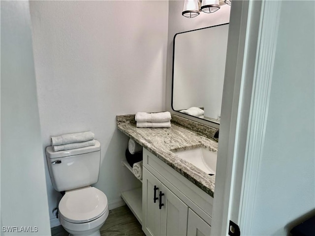 17304 Timber Oak Ln, Fort Myers, FL 33908 - bathroom featuring baseboards, toilet, and vanity