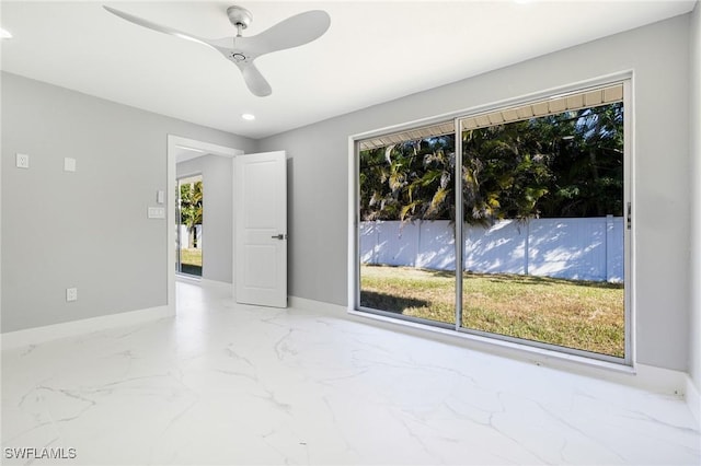 spare room featuring marble finish floor, baseboards, ceiling fan, and recessed lighting