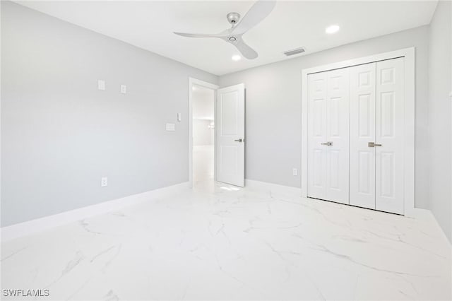 unfurnished bedroom with a closet, marble finish floor, baseboards, visible vents, and recessed lighting