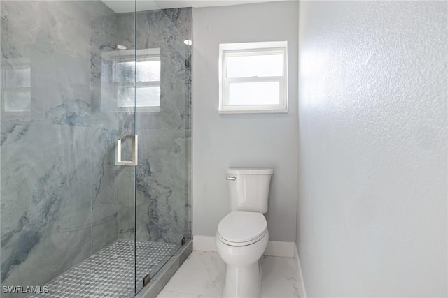 full bath featuring baseboards, a marble finish shower, marble finish floor, and toilet