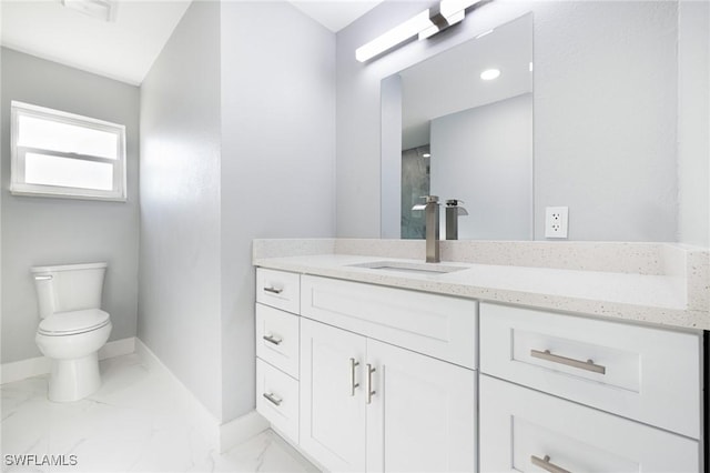 bathroom featuring marble finish floor, toilet, vanity, and baseboards