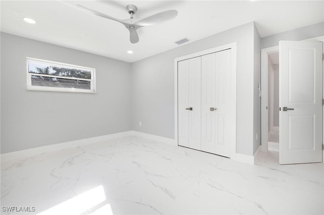 unfurnished bedroom featuring marble finish floor, baseboards, visible vents, and a closet