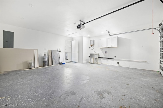 garage with electric panel and a garage door opener
