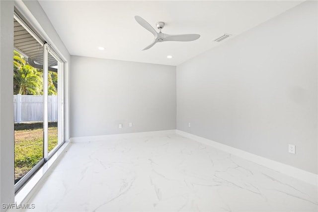 spare room featuring baseboards, visible vents, a wealth of natural light, and marble finish floor