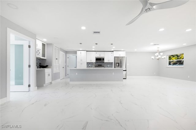unfurnished living room with marble finish floor, an inviting chandelier, baseboards, visible vents, and recessed lighting