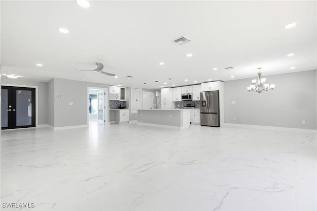 unfurnished living room featuring marble finish floor, baseboards, visible vents, and recessed lighting