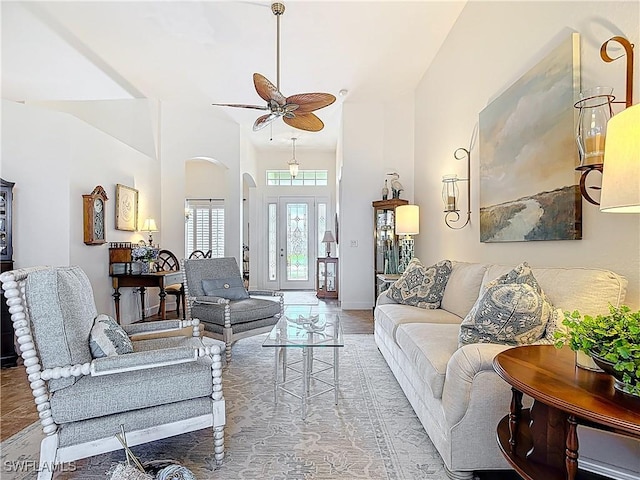 13011 Milford Pl, Fort Myers, FL 33913 - living area with baseboards, a high ceiling, arched walkways, and a ceiling fan