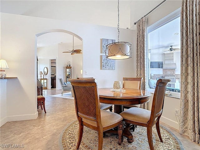 13011 Milford Pl, Fort Myers, FL 33913 - dining area with light tile patterned flooring, baseboards, arched walkways, and ceiling fan