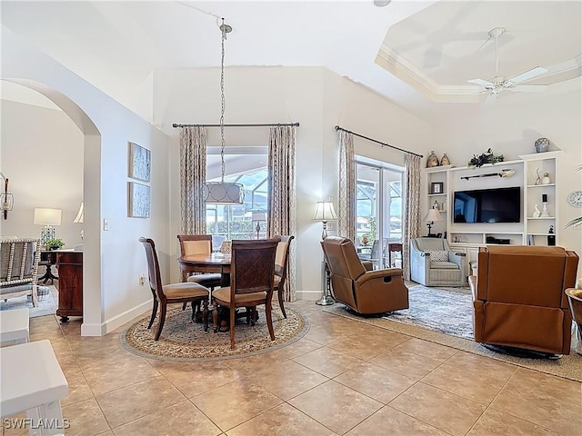 13011 Milford Pl, Fort Myers, FL 33913 - dining room featuring light tile patterned floors, arched walkways, a tray ceiling, and ceiling fan