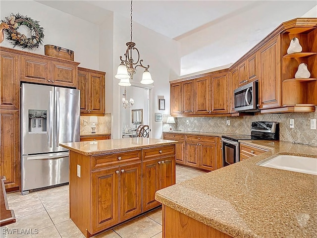 13011 Milford Pl, Fort Myers, FL 33913 - kitchen featuring stainless steel appliances, brown cabinetry, a kitchen island, and open shelves