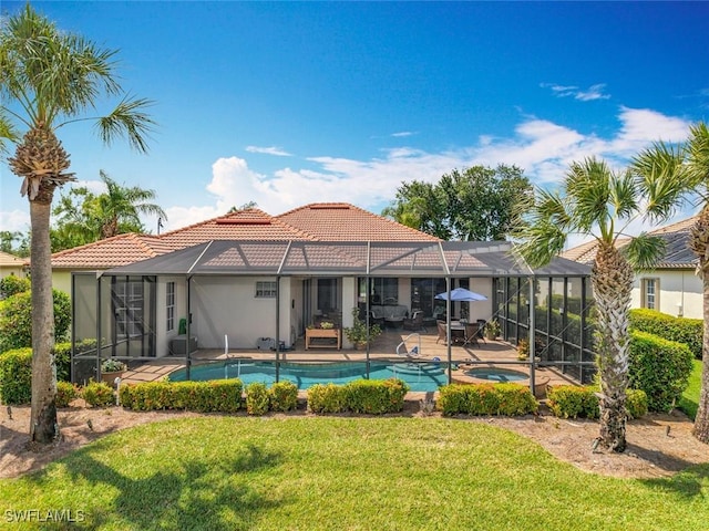 13011 Milford Pl, Fort Myers, FL 33913 - rear view of property featuring stucco siding, a tiled roof, a yard, and glass enclosure