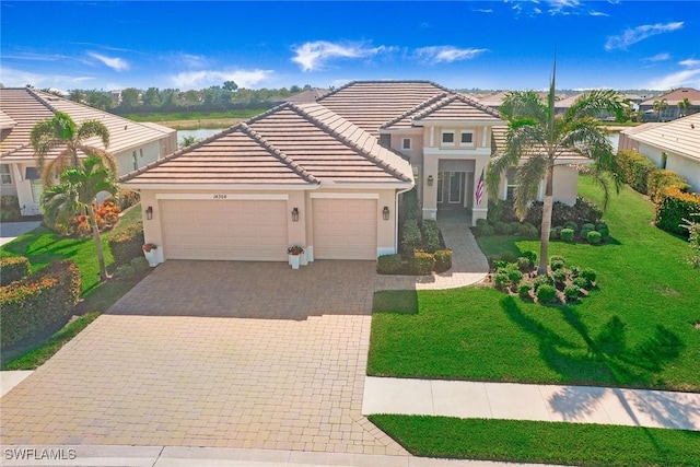 14364 Neptune Ave, Naples, FL 34114 - mediterranean / spanish home with a garage, stucco siding, decorative driveway, and a front yard