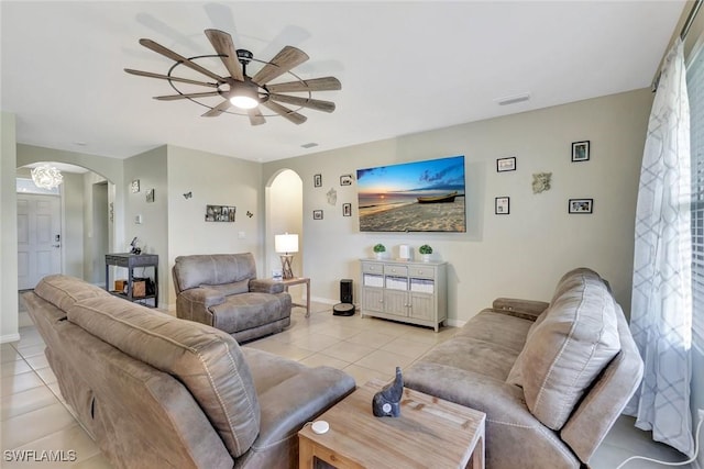 2701 NW Embers Ter, Cape Coral, FL 33993 - living room with arched walkways, ceiling fan, baseboards, and light tile patterned flooring