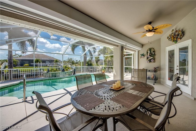 outdoor pool with french doors, fence, a lanai, a patio, and ceiling fan