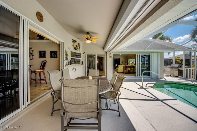 view of patio with an outdoor pool, outdoor dining area, glass enclosure, and ceiling fan