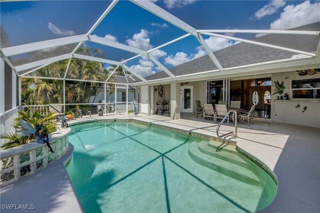 outdoor pool with a lanai and a patio