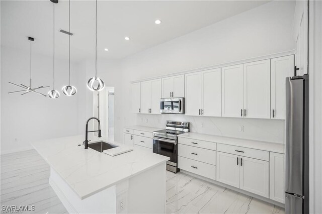 203 Old Burnt Store Rd S, Cape Coral, FL 33991 - kitchen with white cabinetry, an island with sink, stainless steel appliances, and a sink