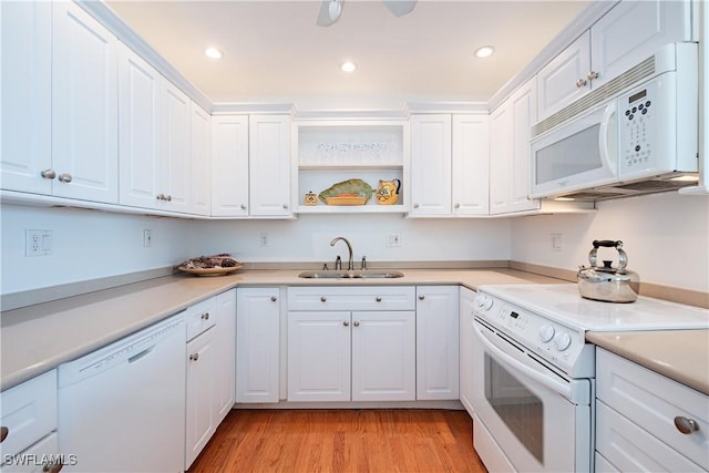 kitchen featuring recessed lighting, white appliances, light wood-style flooring, white cabinets, and a sink