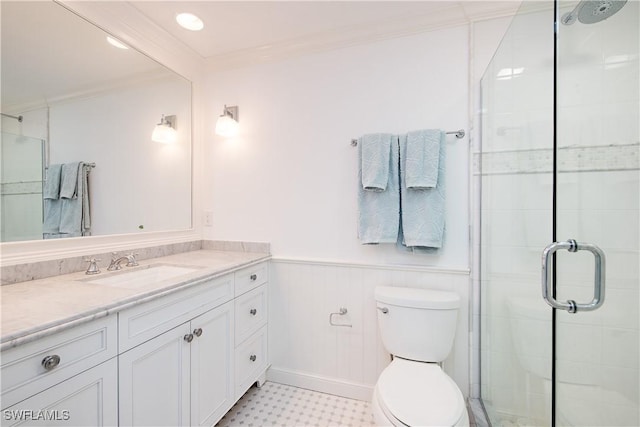 full bath featuring a shower stall, vanity, ornamental molding, toilet, and wainscoting