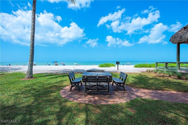 exterior space with a water view and a view of the beach